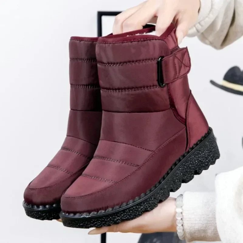 Women's waterproof boots in red with a sleek silhouette and cushioned sole