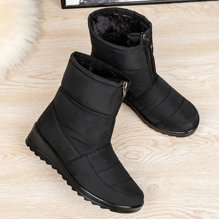 Women's waterproof boots in gray styled with a midi skirt