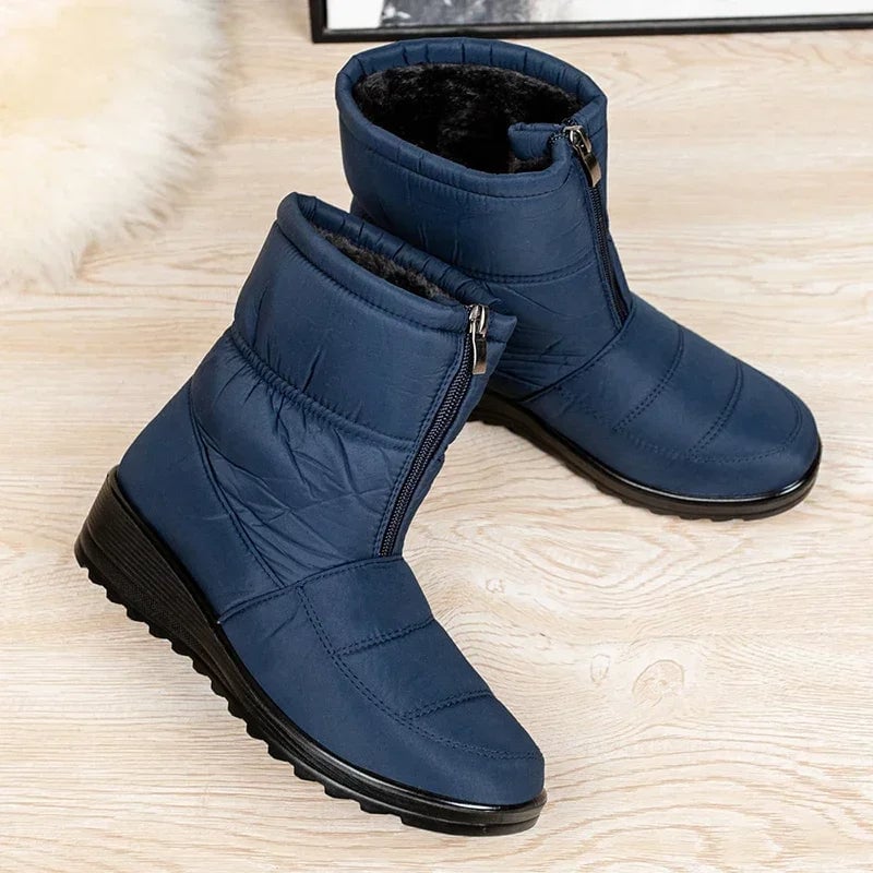 Women's waterproof boots in khaki shown on model from ankle up