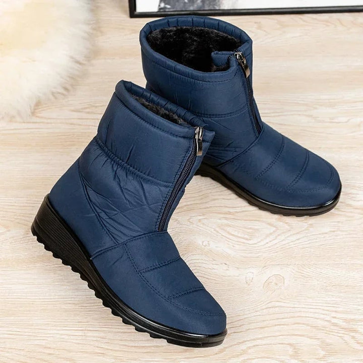 Women's waterproof boots in khaki shown on model from ankle up