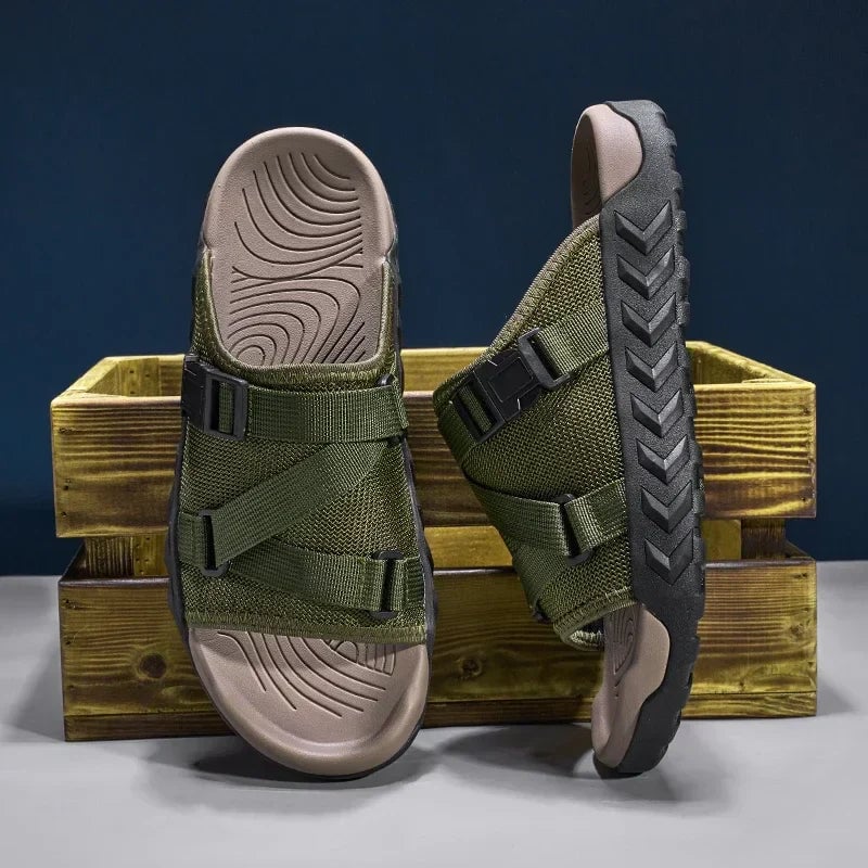 Joy women's slip-on slippers in green worn on feet against a neutral lifestyle background