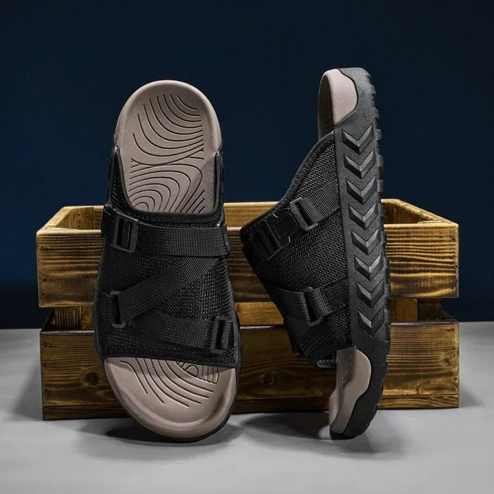 Flat-lay of all three Joy slipper color options — khaki, green, and black — arranged together