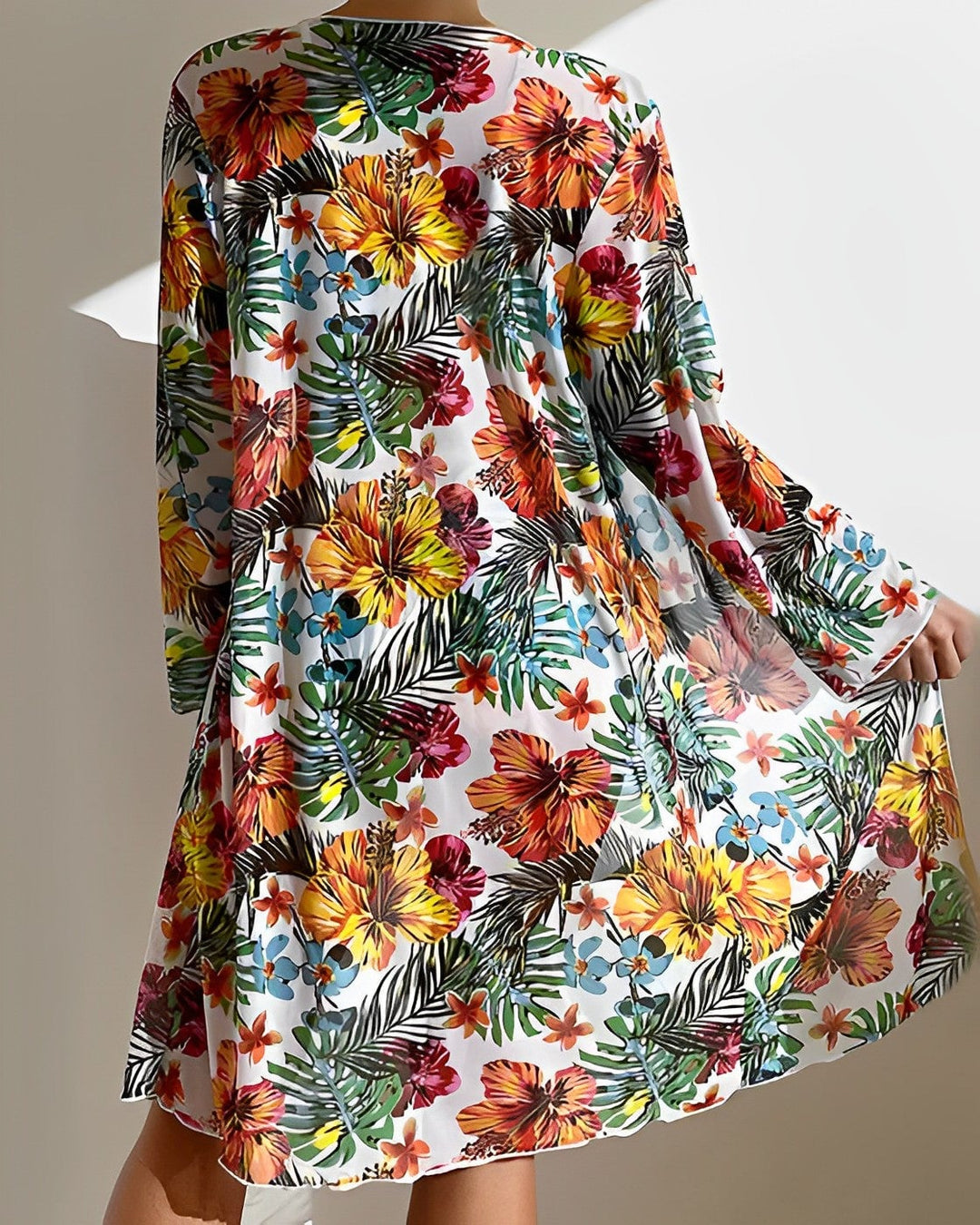 Model styling the tropical bikini cover-up over swimsuit for a beach-to-street resort look