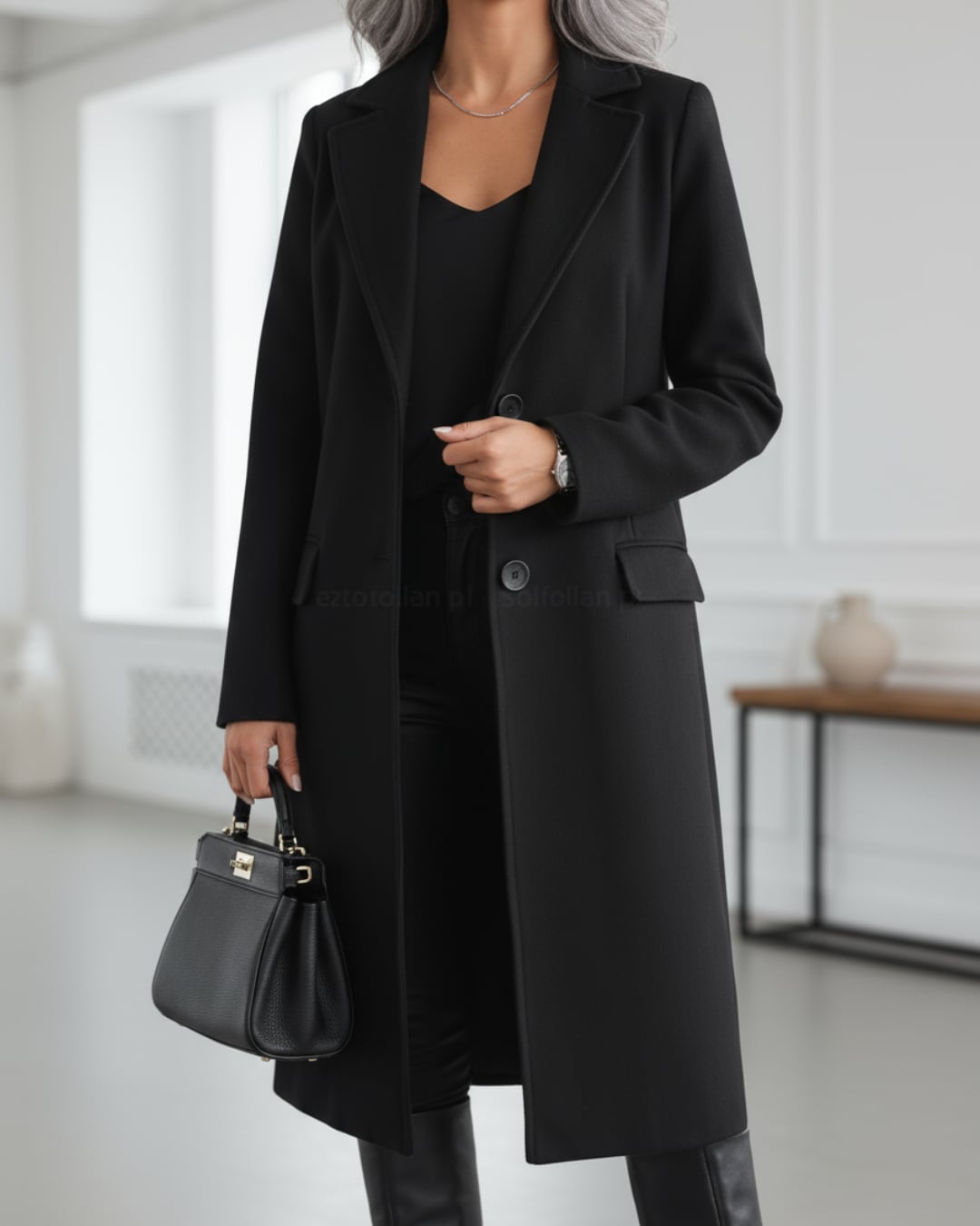 Model styled in the Judith long coat paired with boots, demonstrating versatile everyday elegance