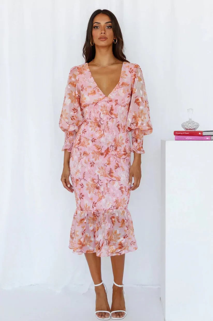 Back view of the Julia floral dress in pink with flowing skirt