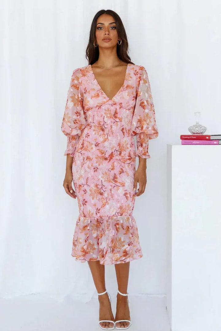 Back view of the Julia floral dress in pink with flowing skirt