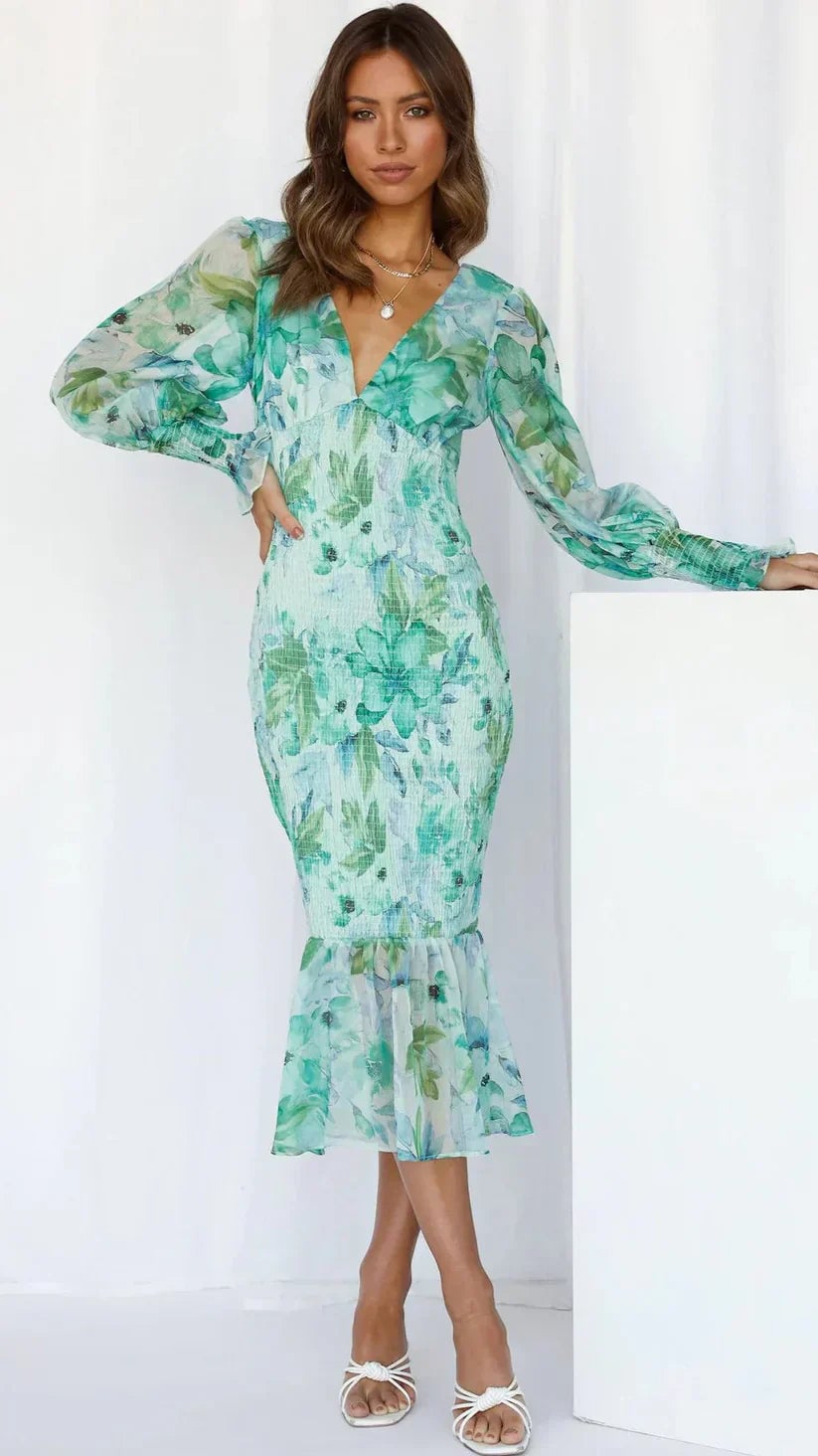 Side view of the Julia floral dress in green showing the lightweight fabric in motion