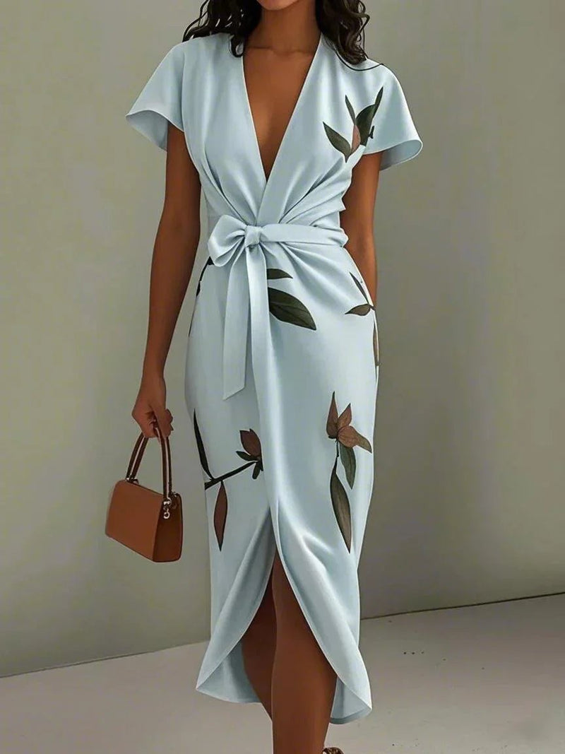 Close-up of the delicate leaf print fabric on the white wrap dress