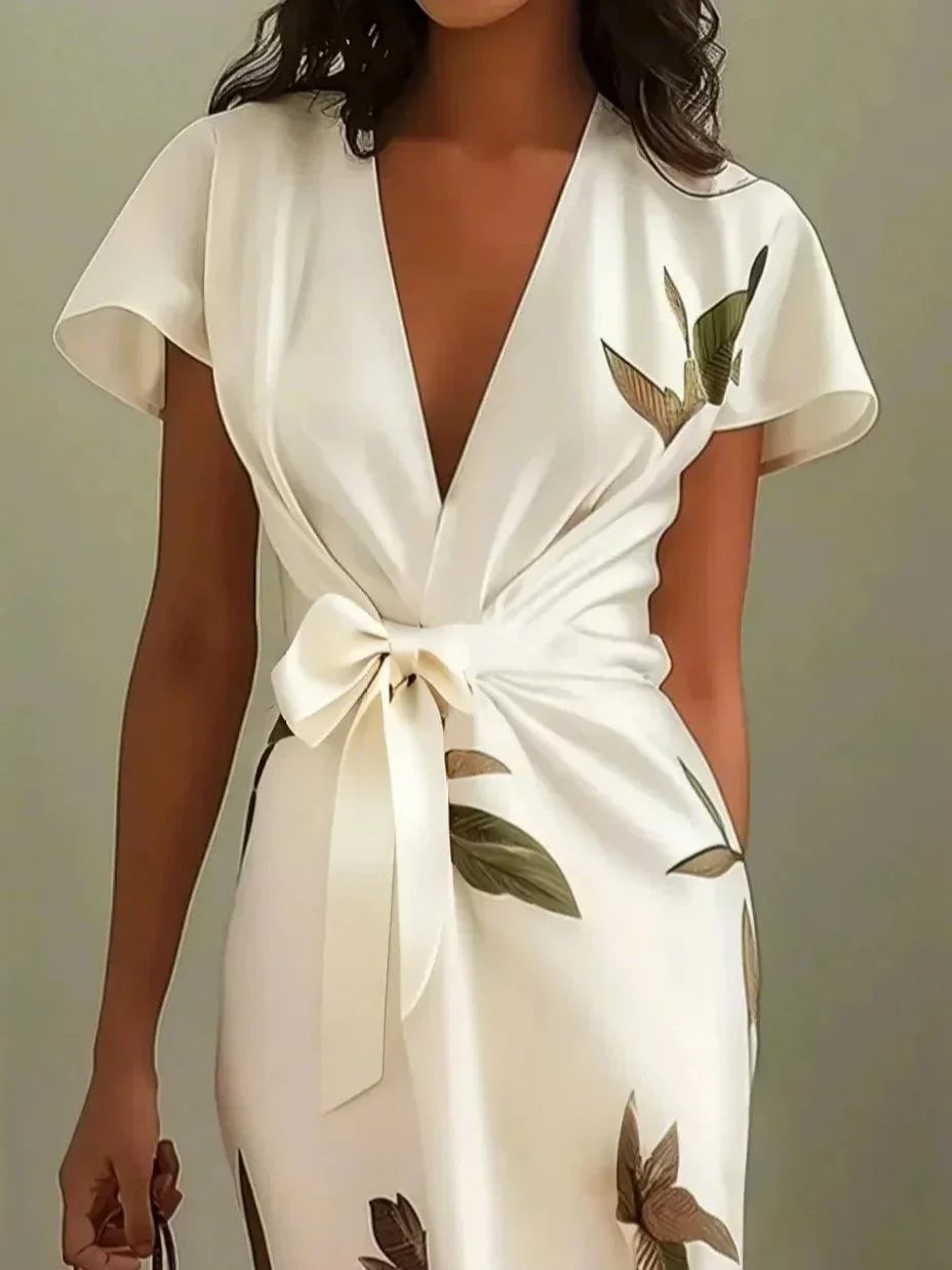 Side view of the flowing wrap dress silhouette in white
