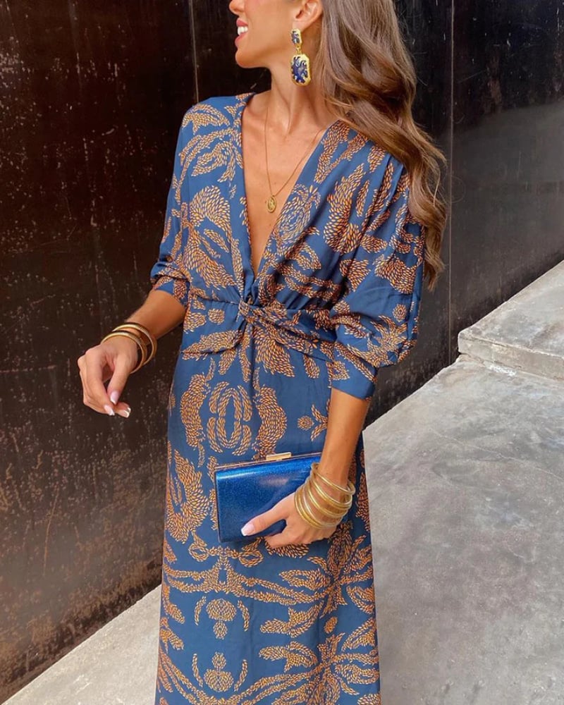 Model in a pink long sleeve maxi dress posing at a formal event setting