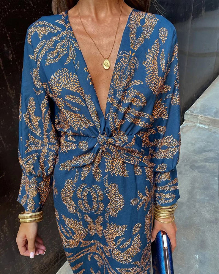 Side profile of a blue long sleeve maxi dress highlighting the flowing silhouette