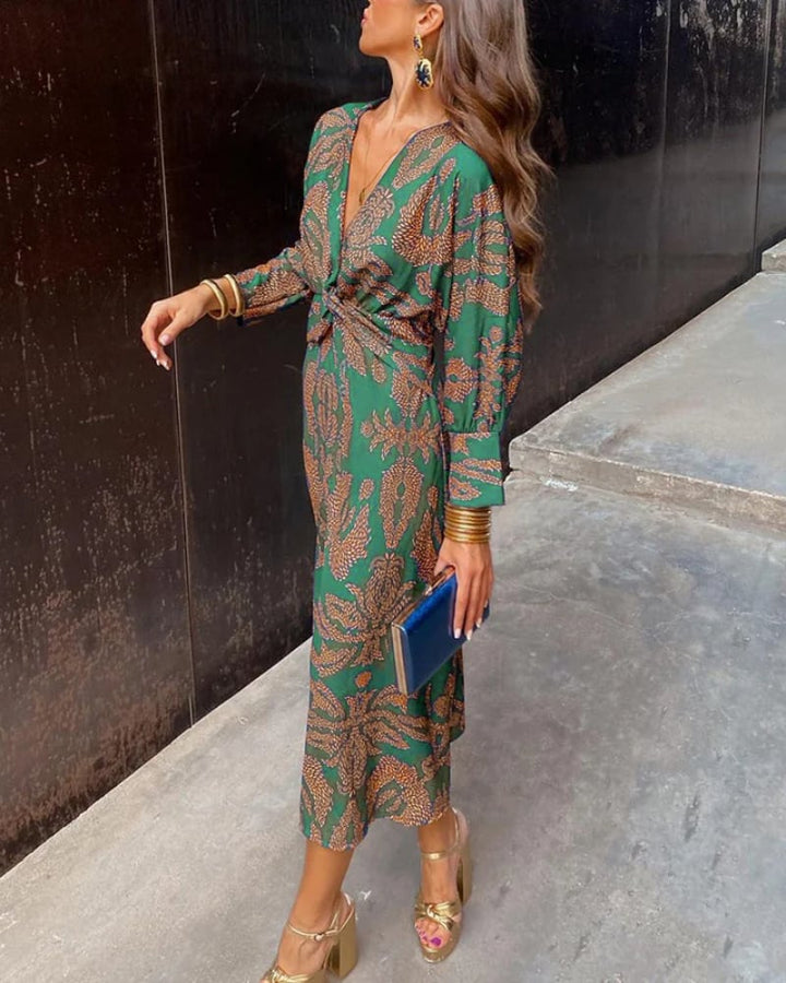 Full-length back view of a green long sleeve maxi dress with graceful drape detail