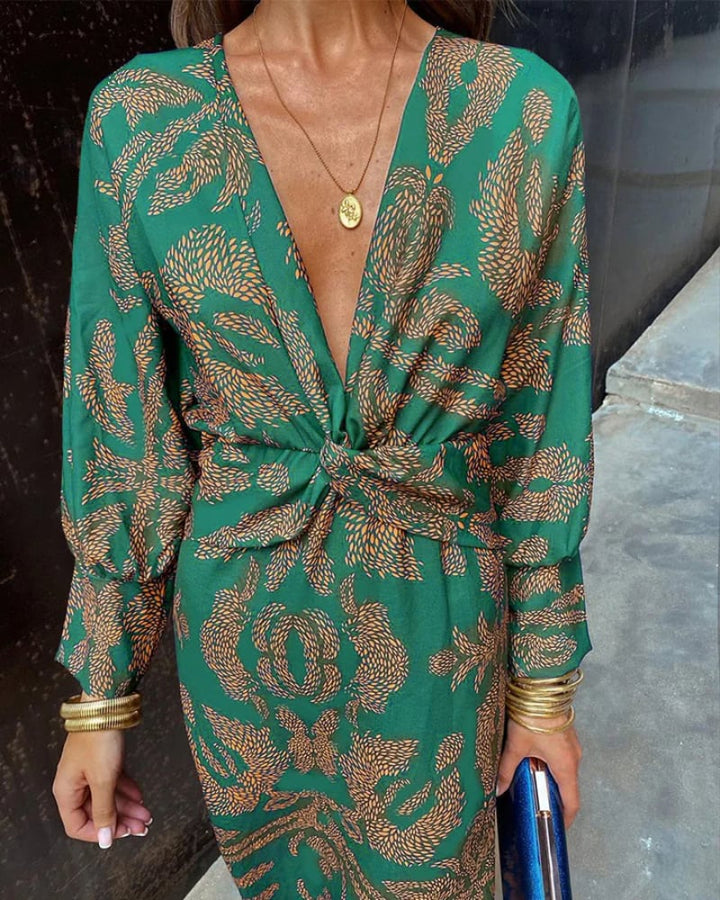 Model wearing a red long sleeve maxi dress paired with strappy heeled sandals