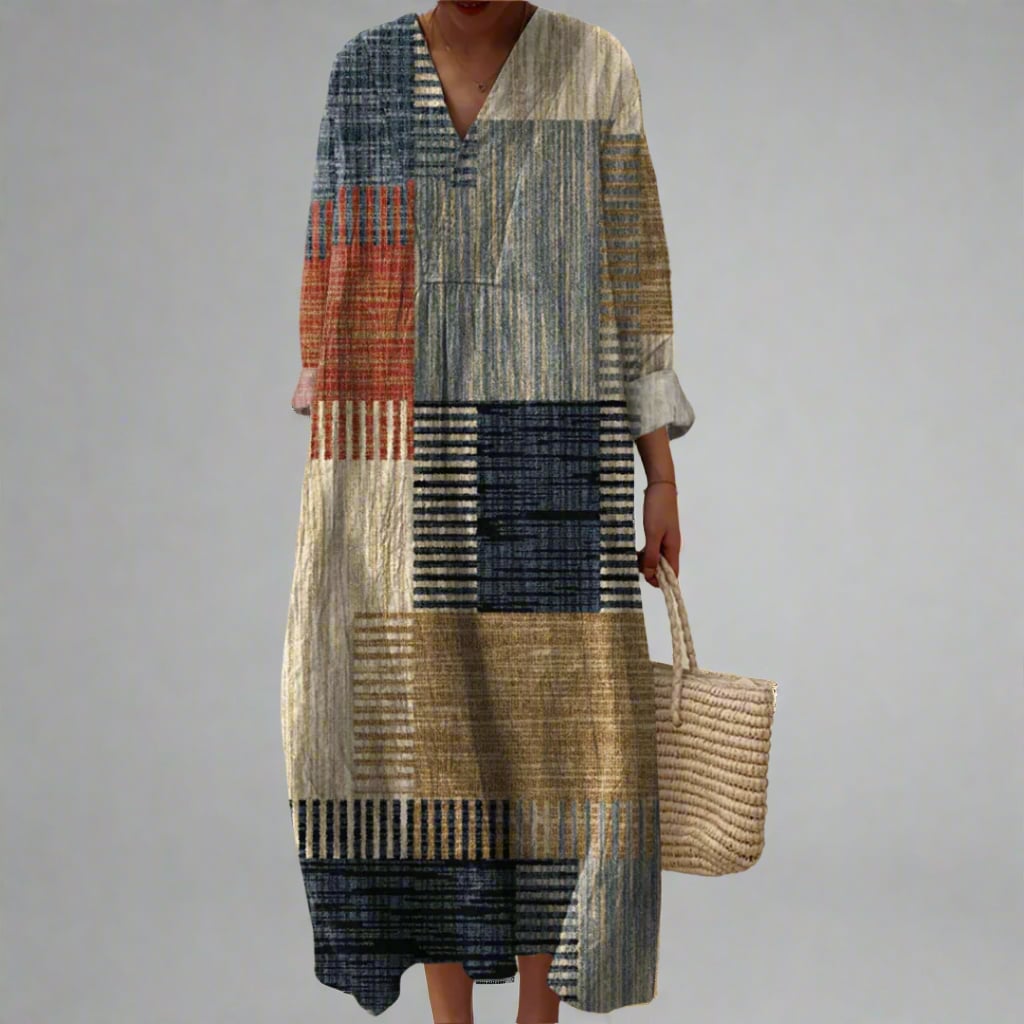 Woman wearing an elegant geometric print dress with a flowing silhouette in a modern, dream-inspired pattern