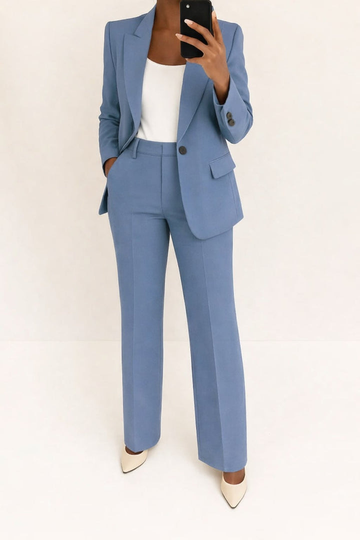 Woman wearing the Julie two-piece suit in a tailored blazer and matching pants, styled for a polished office look