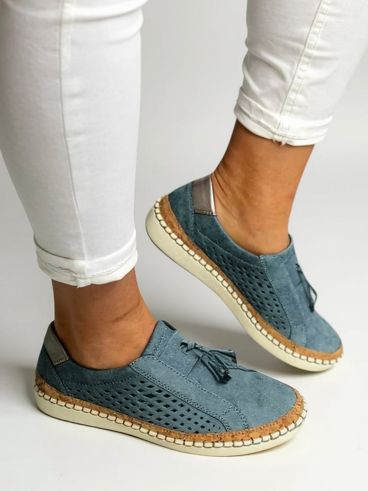 Juliette tassel slip-on shoes in black showing chic tassel detailing, side profile view
