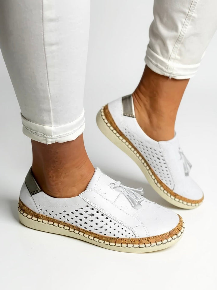 Juliette tassel slip-on shoes in blue displayed at an angle highlighting the slip-on design