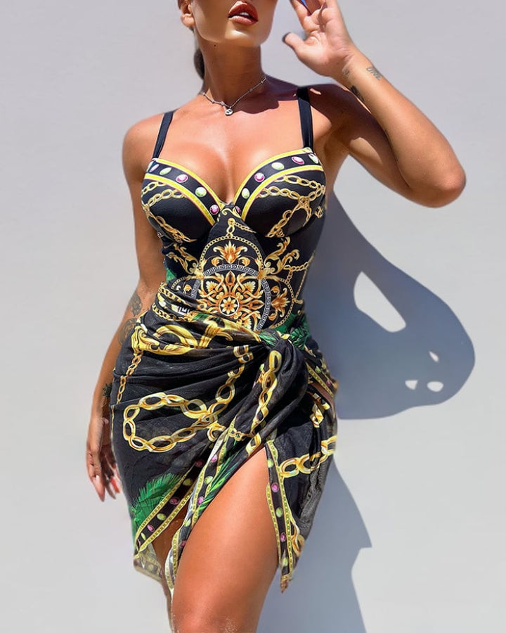 Woman wearing the Juliette black tummy control push-up swimsuit with matching flowy beach skirt at the shore