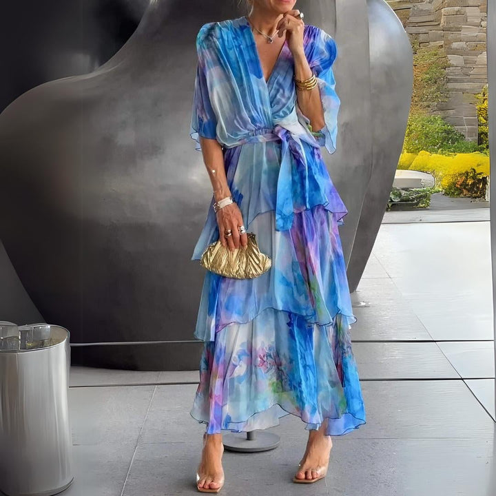 Woman wearing a blue v-neck flowy draped cocktail dress with tummy control, front view showing flattering silhouette