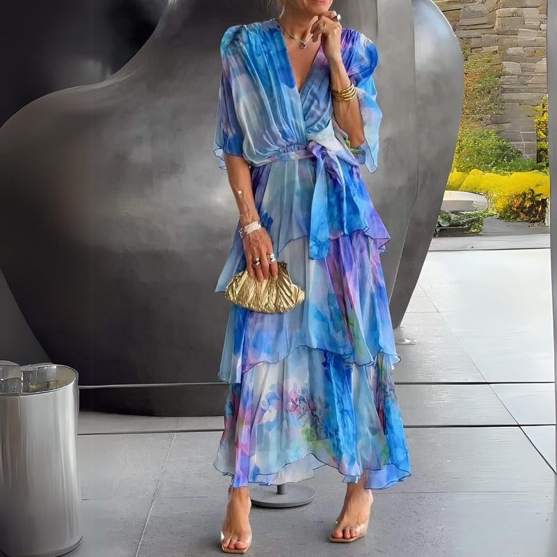 Woman wearing a blue v-neck flowy draped cocktail dress with tummy control, front view showing flattering silhouette