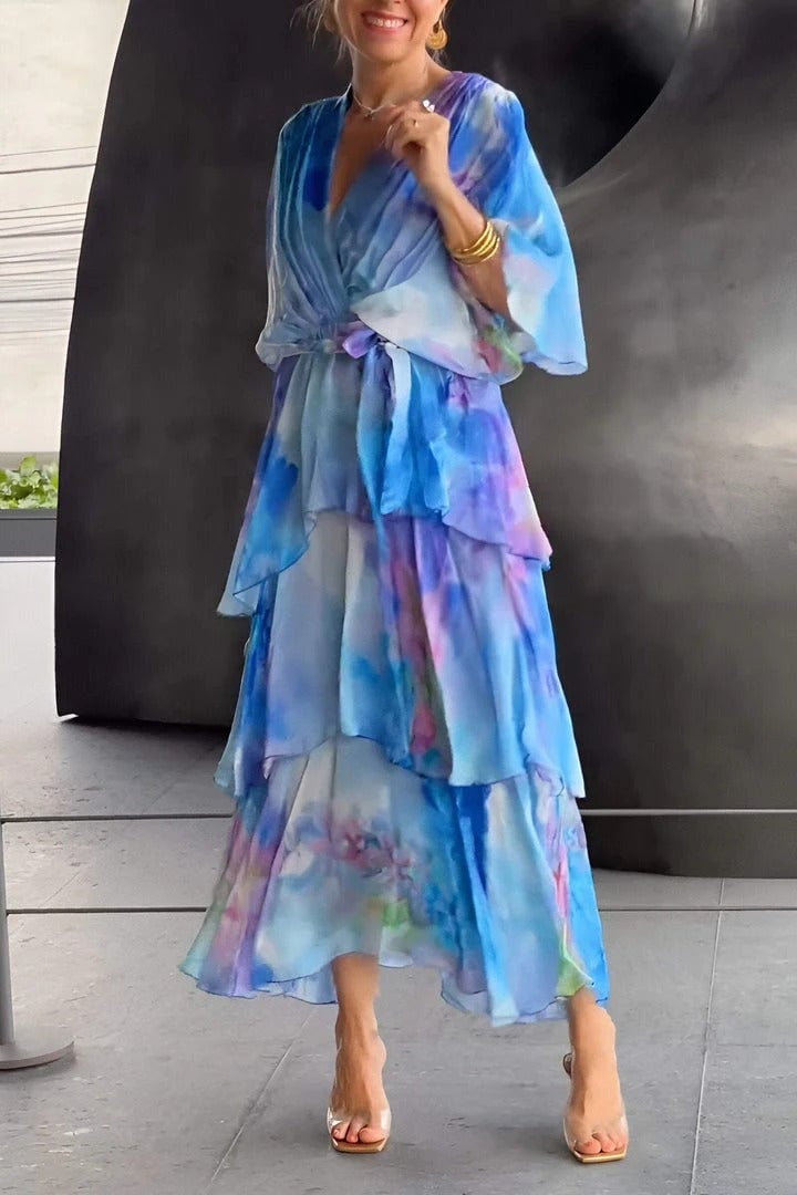 Side view of the Juliette blue draped dress highlighting the flowing fabric and defined waist shaping