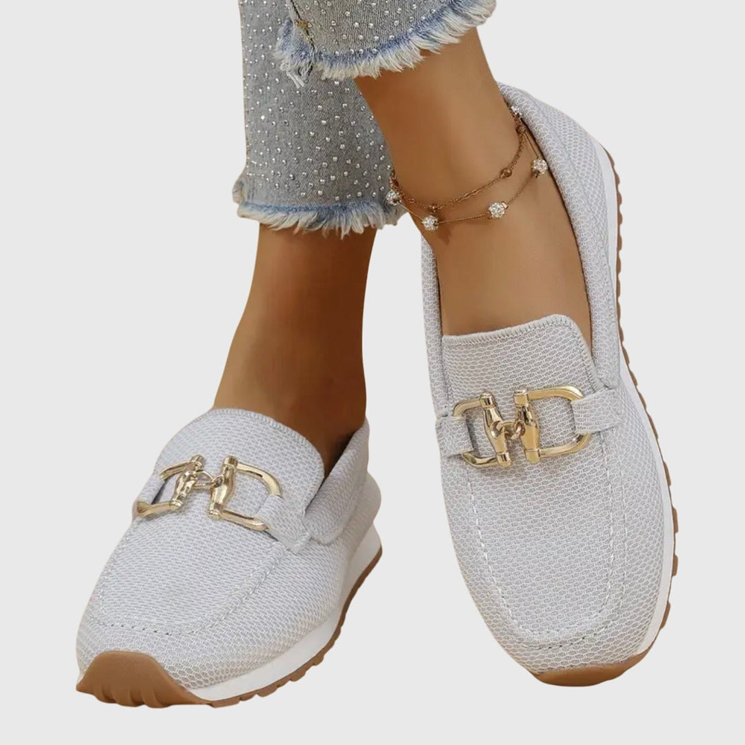 Pair of June orthopedic loafers in beige displayed on a flat surface, angled view