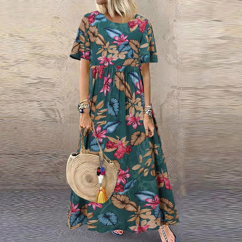 Side profile of the Juniper floral maxi dress in green highlighting the flowing fabric and figure-flattering fit