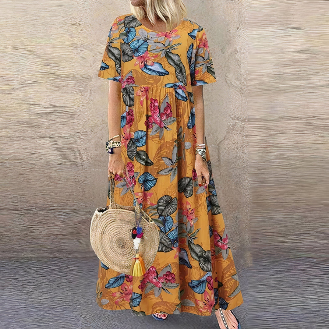 Close-up detail of the Juniper floral lace maxi dress in yellow showing the print and fabric texture
