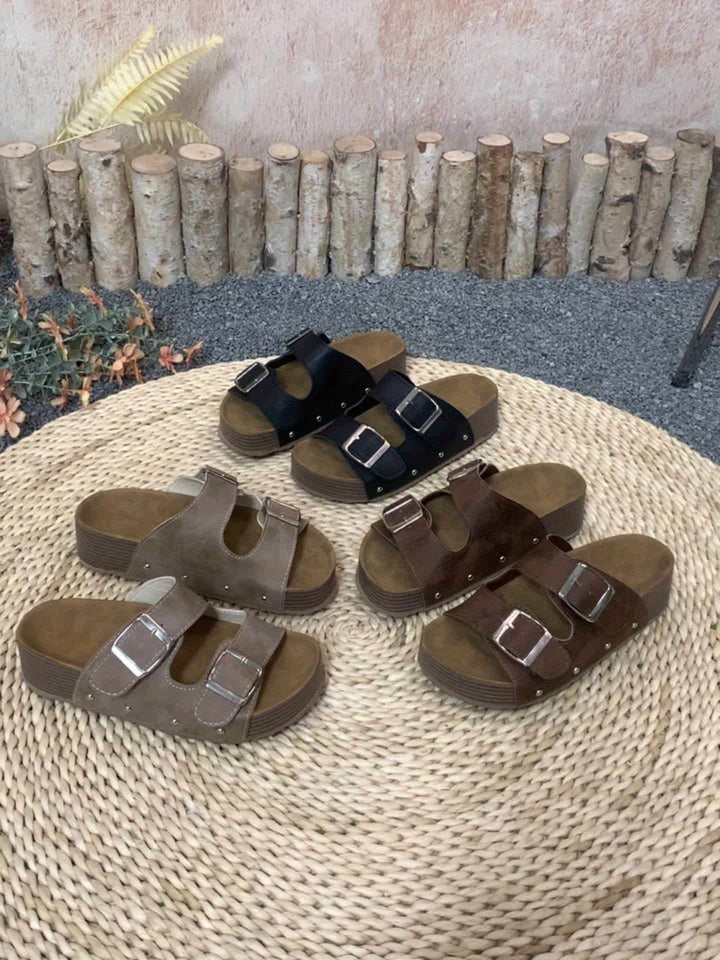 Lifestyle shot of Juniper sandals worn outdoors on a sunny day