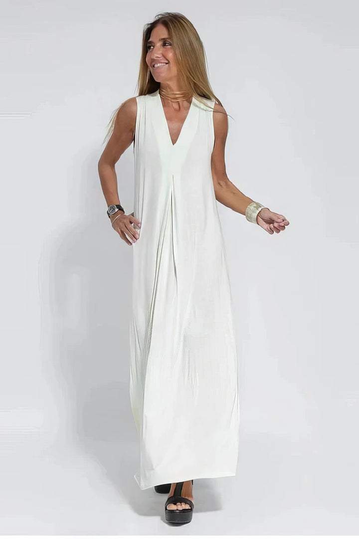 White long dress with coordinated cardigan displayed on a model, showing the elongated elegant silhouette