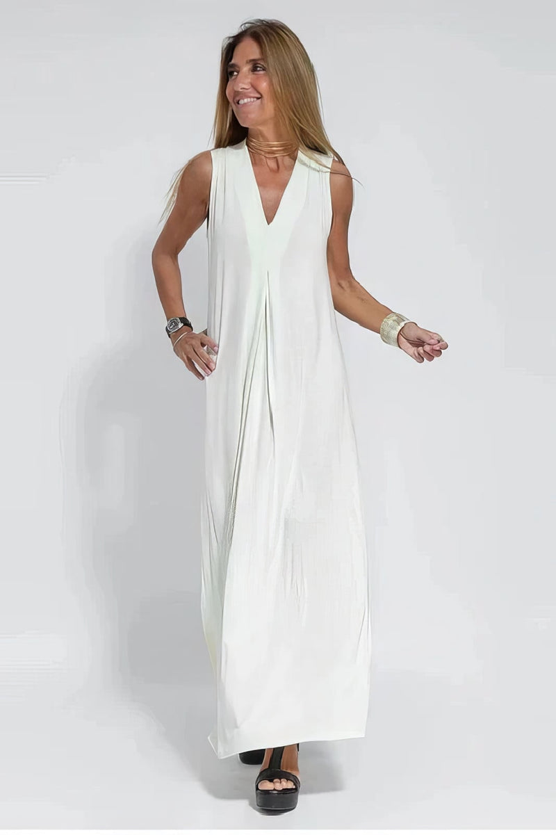 White long dress with coordinated cardigan displayed on a model, showing the elongated elegant silhouette