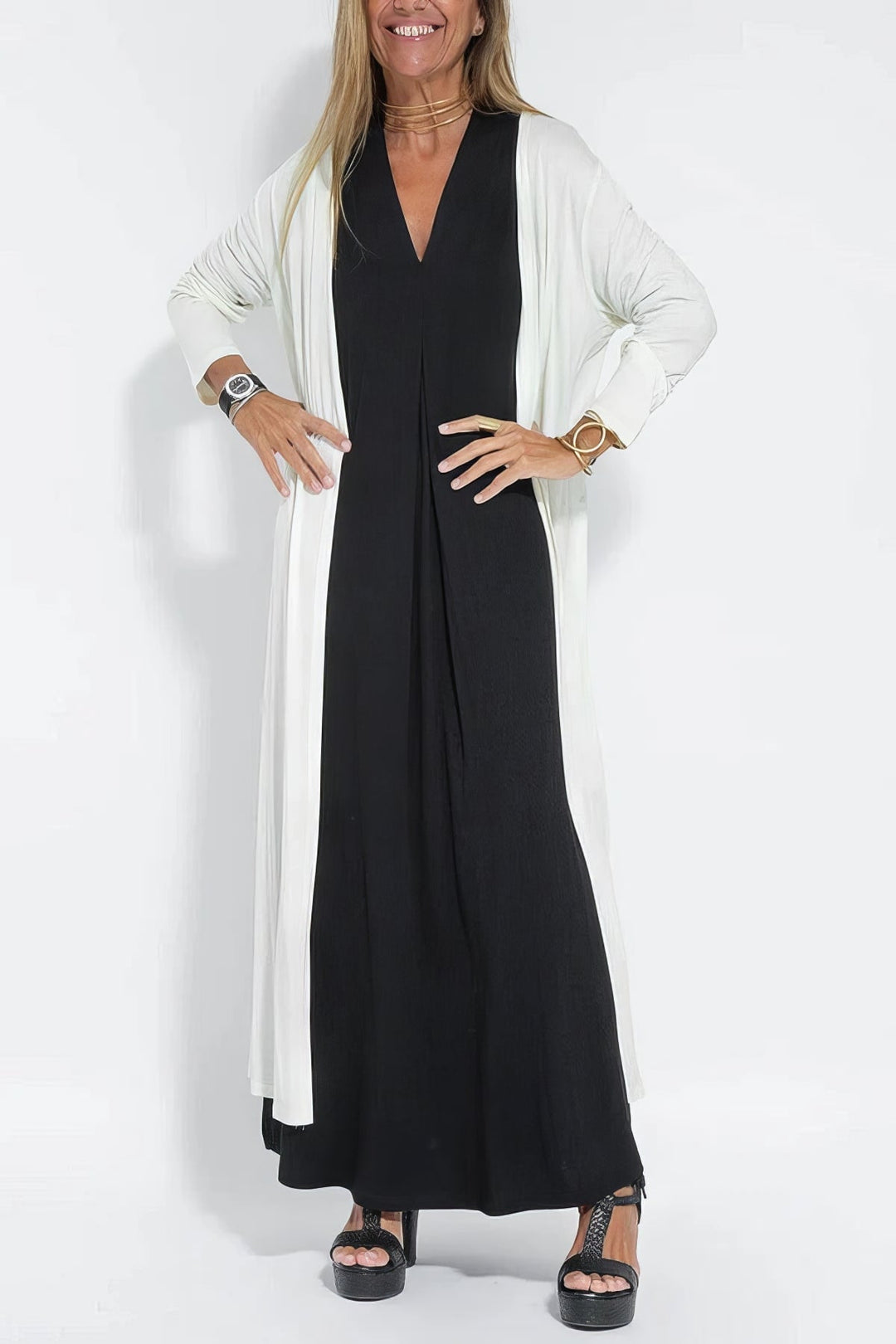 Full-length side view of a black long dress with matching cardigan, emphasizing the flowing cut