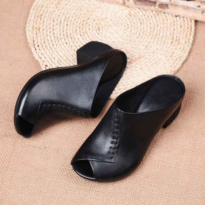 Kalani slip-on sandals styled on feet with linen trousers, dark brown colorway
