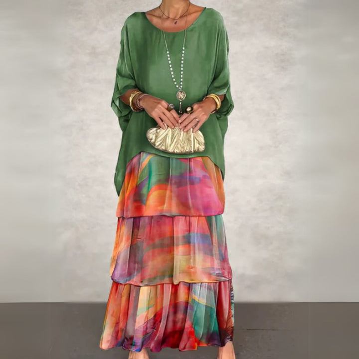 Woman wearing an elegant long flowing dress with a soft drape and slim silhouette in a light color