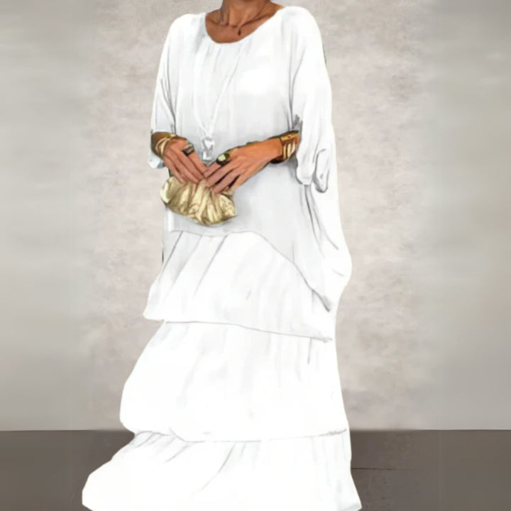 Long flowing dress in dark green color shown on a model in a natural outdoor setting