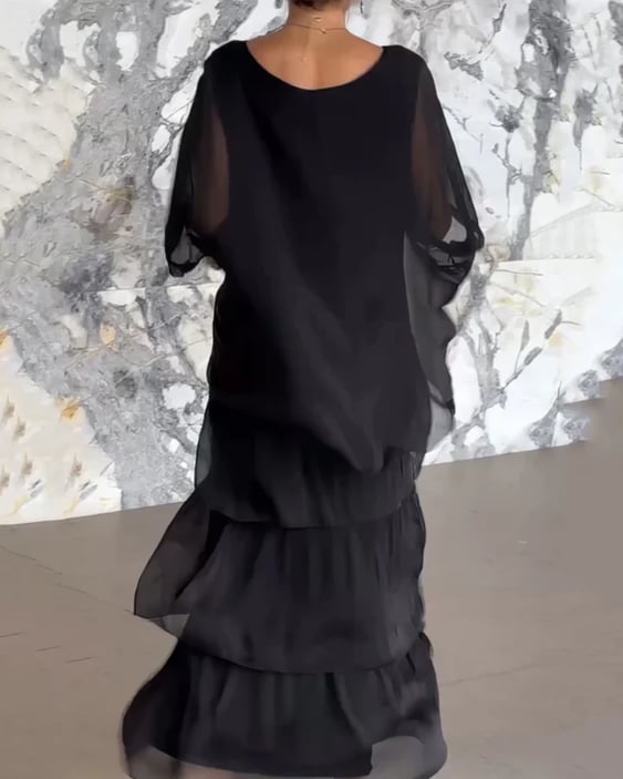 Woman wearing the long flowing dress in white styled with heels for a formal occasion