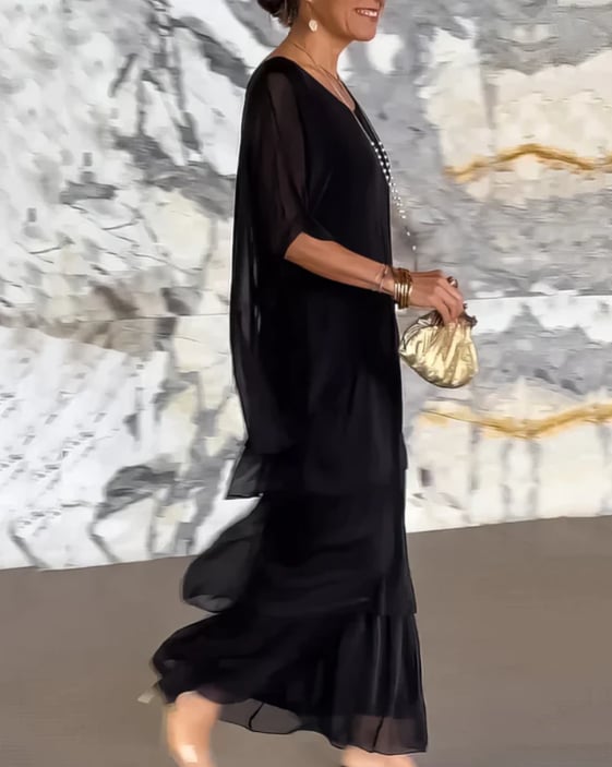 Long flowing dress in dark pink displayed on a model with a relaxed, effortless pose