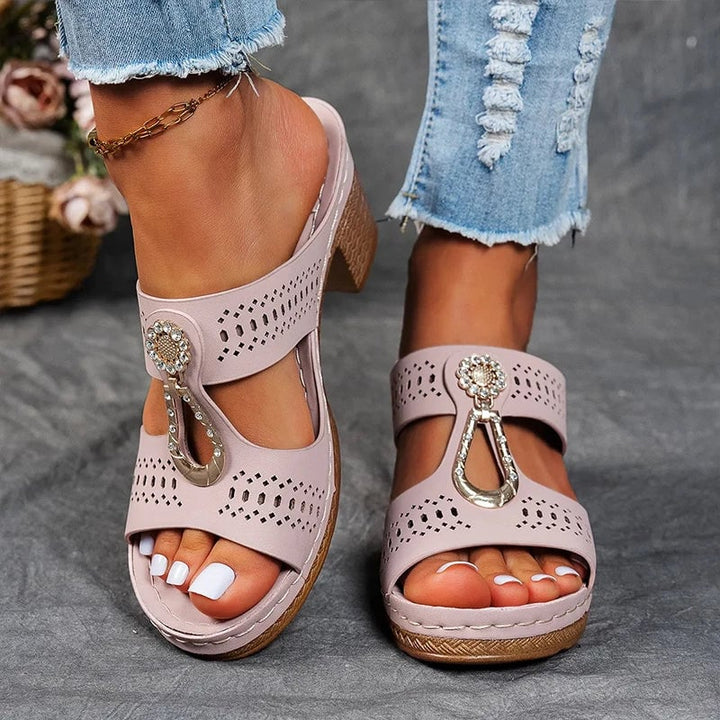 Women wearing orthopedic wedge sandals in black, showing posture-enhancing heel lift