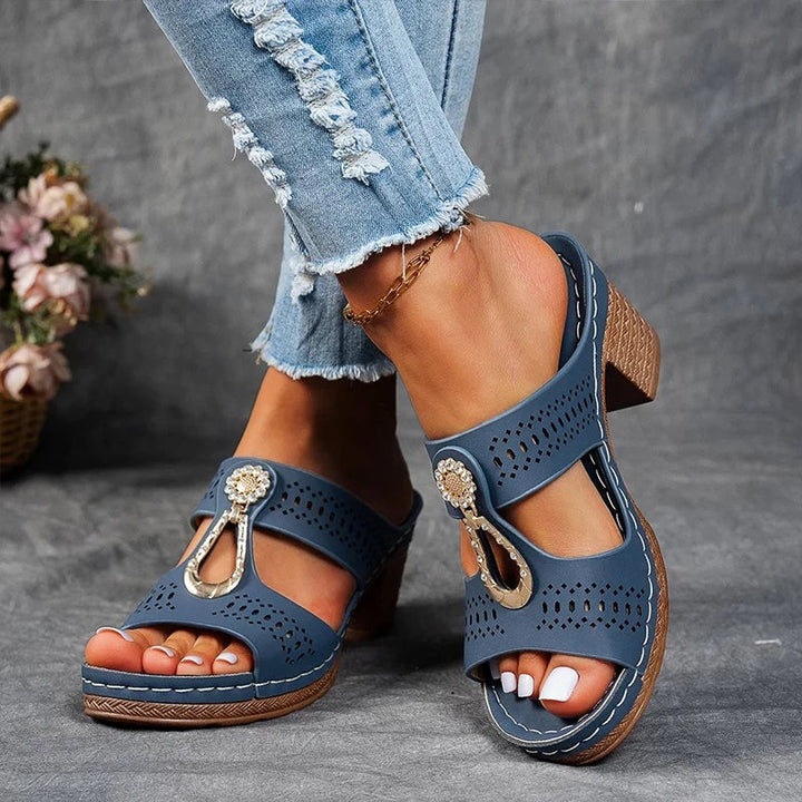 Detail shot of sparkling stone accent on the strap of a women's wedge sandal in pink