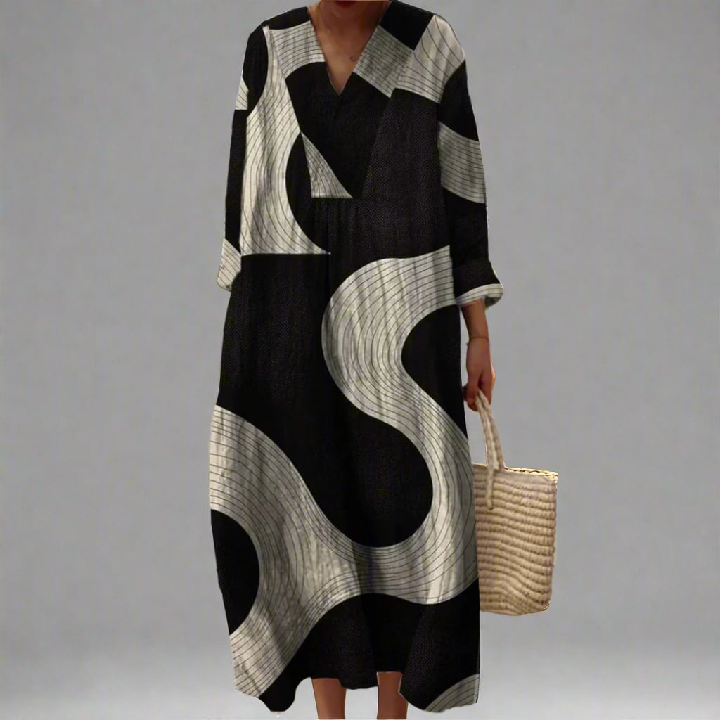 Model wearing an elegant flowing dress with a bold geometric print pattern in a relaxed, figure-flattering silhouette