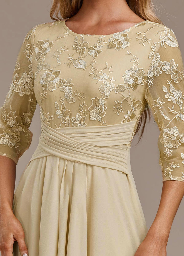 Side view of champagne embroidered dress showing 3/4 sleeve length and flowing skirt