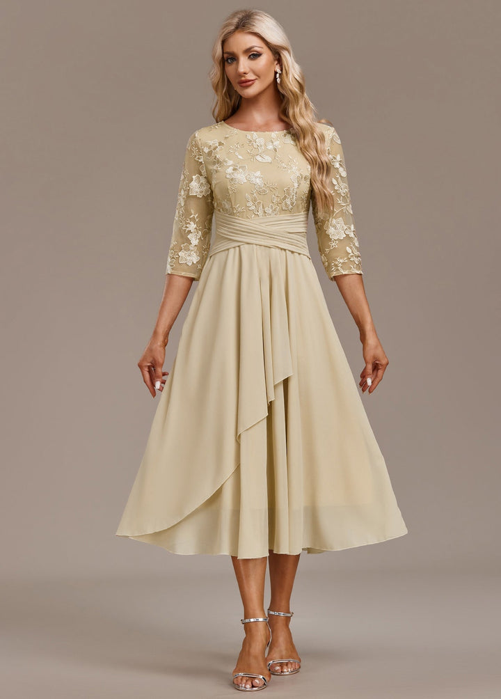 Close-up of delicate floral embroidery detail on champagne dress bodice