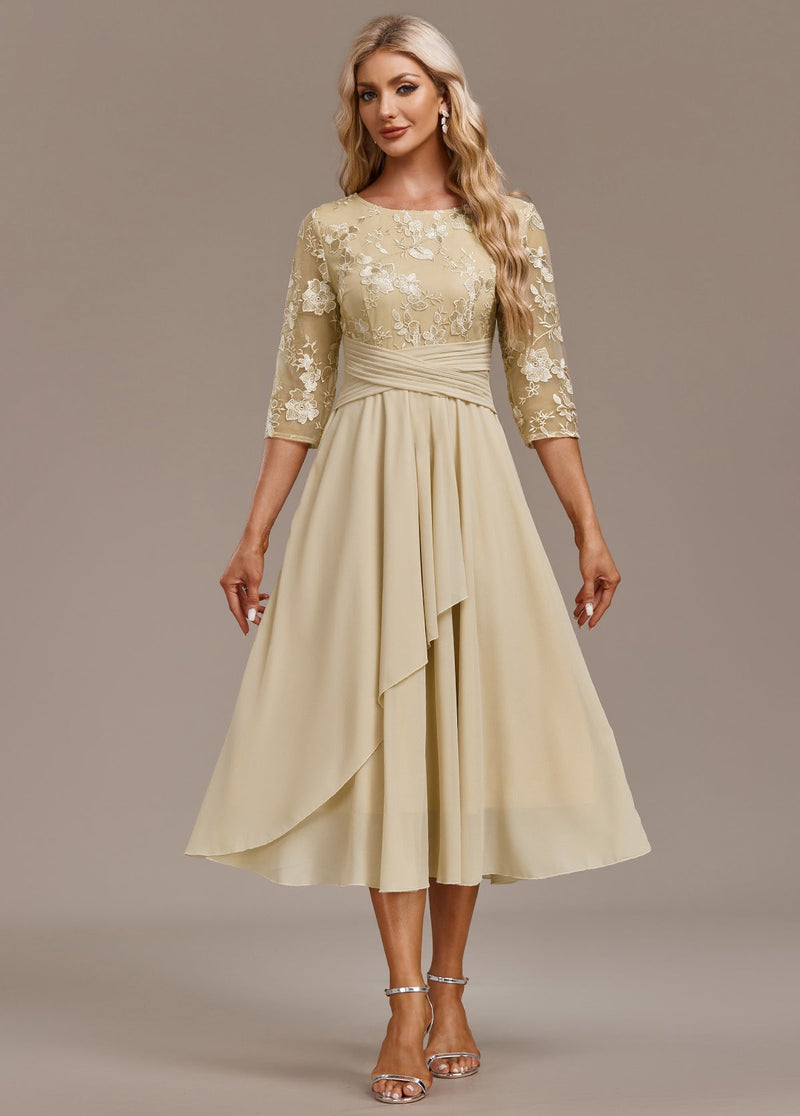 Close-up of delicate floral embroidery detail on champagne dress bodice