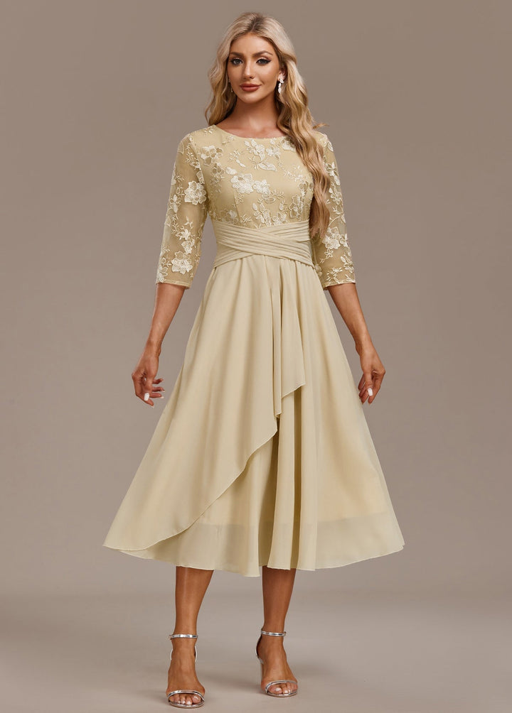 Full-length lifestyle shot of model wearing champagne floral embroidered dress at a formal occasion