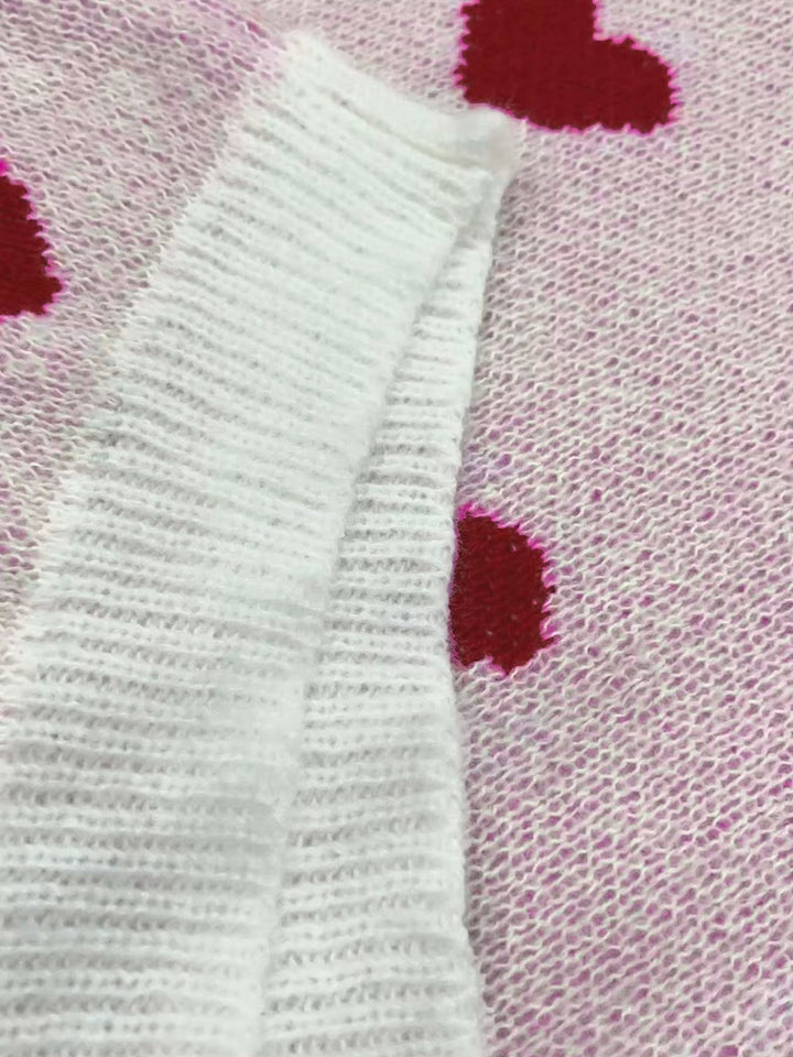 Side view of the Elegant Hearts Sweater in white showing graceful drape and comfortable fit