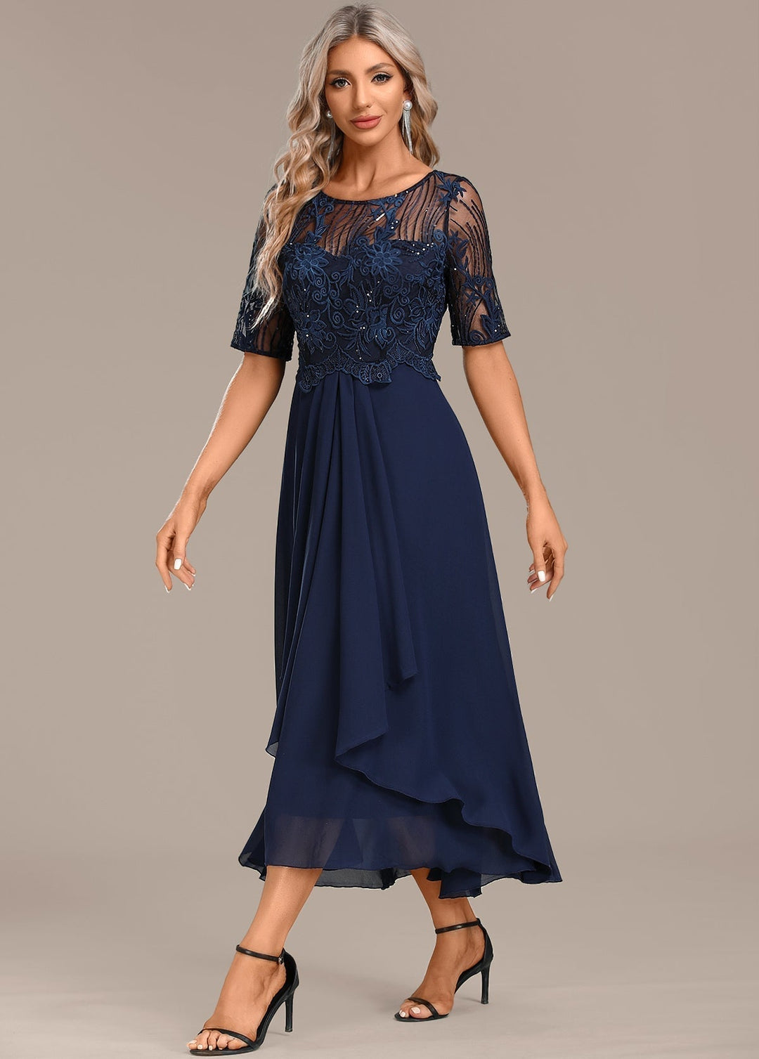 Close-up of delicate navy lace fabric detailing on a short sleeve round neck dress