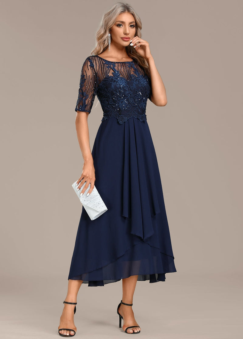 Full-length back view of a navy lace round neck dress with short sleeves