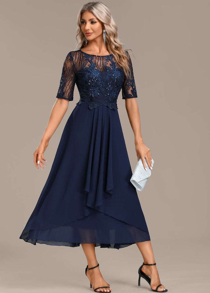 Detail shot of the round neckline and lace texture on a navy short sleeve dress