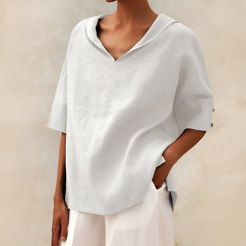 Model wearing a relaxed-fit lightweight blouse in a neutral color, styled casually