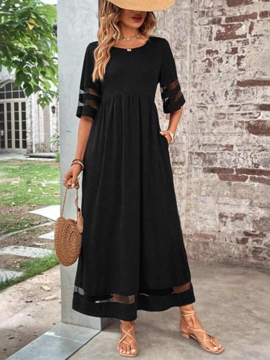 Front view of the chic tummy-flattering coverage dress in black, showing the graceful flowing silhouette